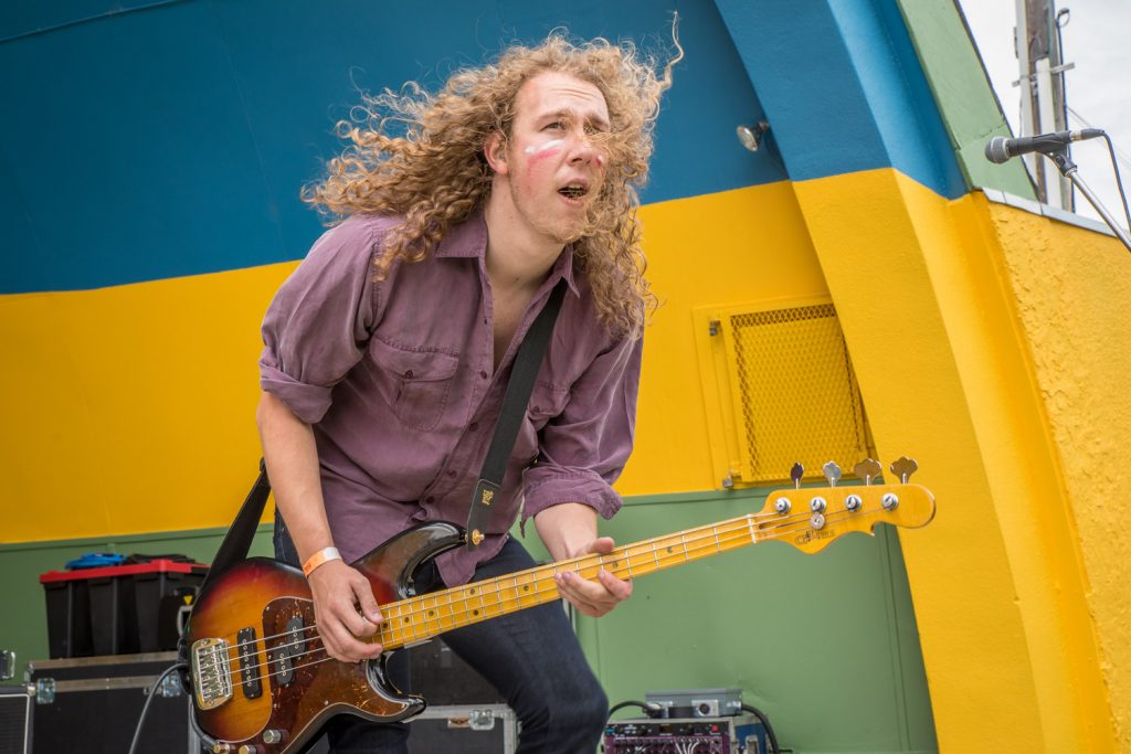 Kris Marsel, bass guitarist with Cosmic Brew, had Gyro Park rocking Friday afternoon. Also on stage with the band were Mason Burns (lead singer and guitarist) and Josh Visser on drums. (Richard McGuire photo)