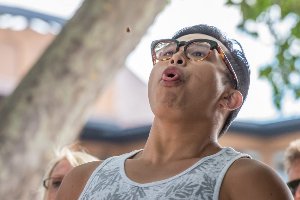 Perry Yung, of Calgary, curls his tongue for extra power as he fires a cherry pit into the air in the pit spitting contest. (Richard McGuire photo)
