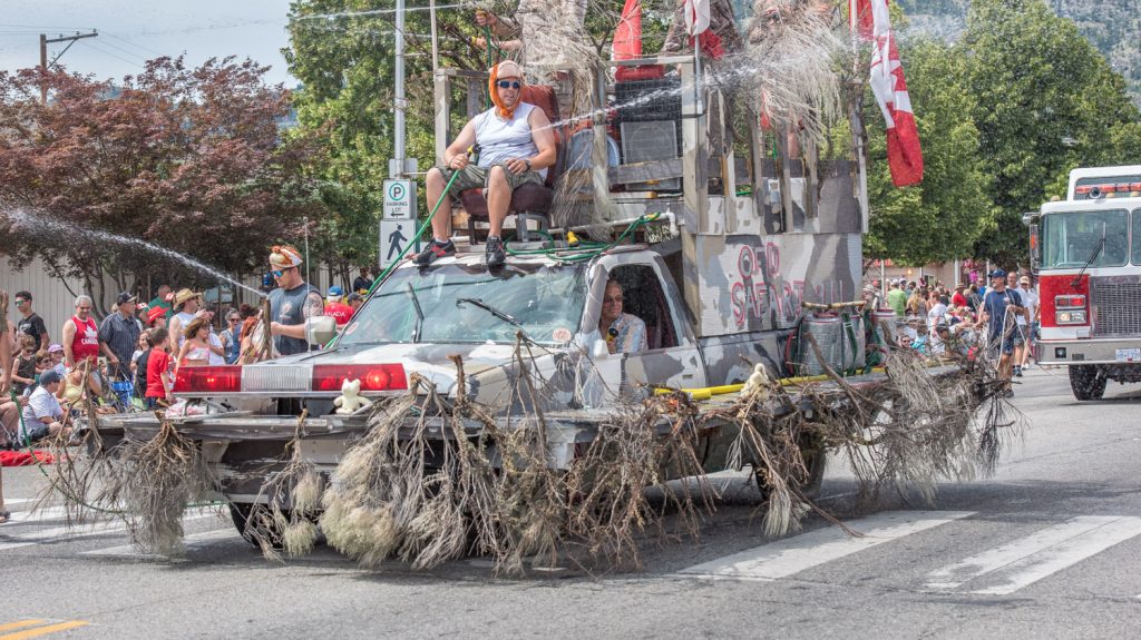 Osoyoos firefighters advanced down Main Street in their camoflaged safari vehicle ready to take on swarms of children in an epic water fight. (Richard McGuire photo)