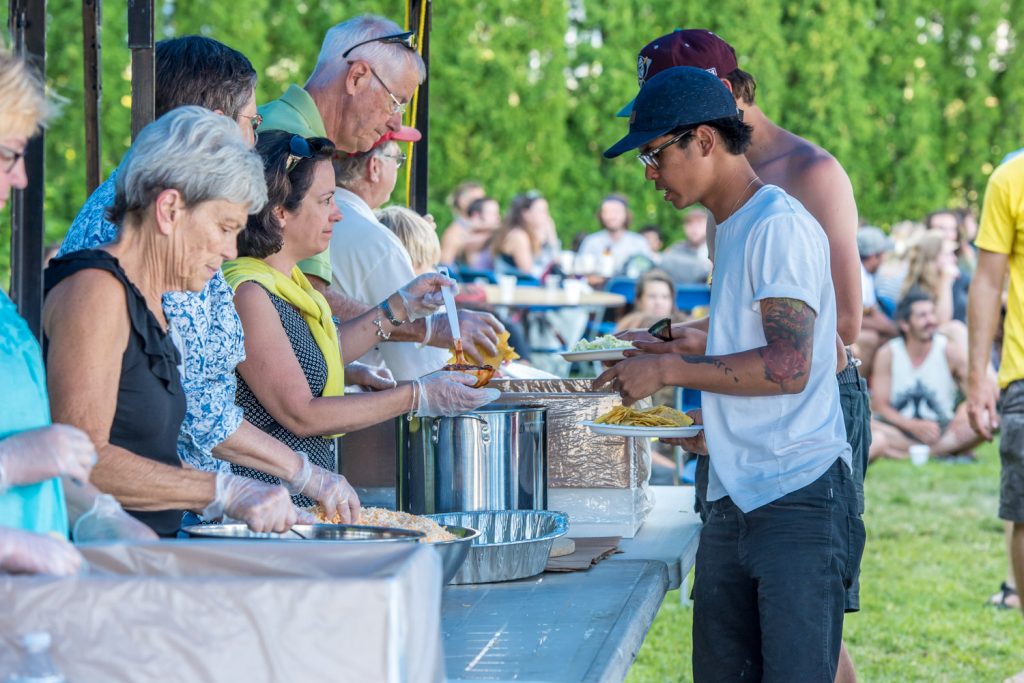 Fruit pickers lined up Wednesday evening at Osoyoos Baptist Church for a free dinner of Mexican-style nachos, beans and salsa. The church has been providing the dinners all week in partnership with Mountain Park Community Church from Abbotsford. (Richard McGuire photo)