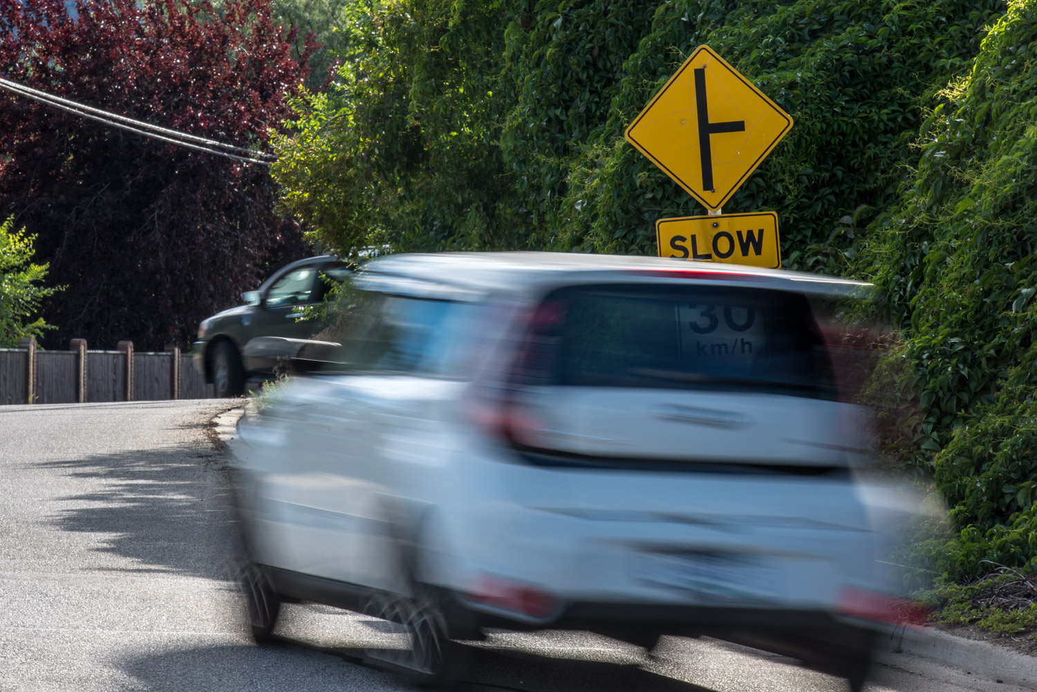 A vehicle ahead turns off Osprey place just as another vehicle is driving up the hill to the blind intersection on 62nd Ave. (Richard McGuire photo)