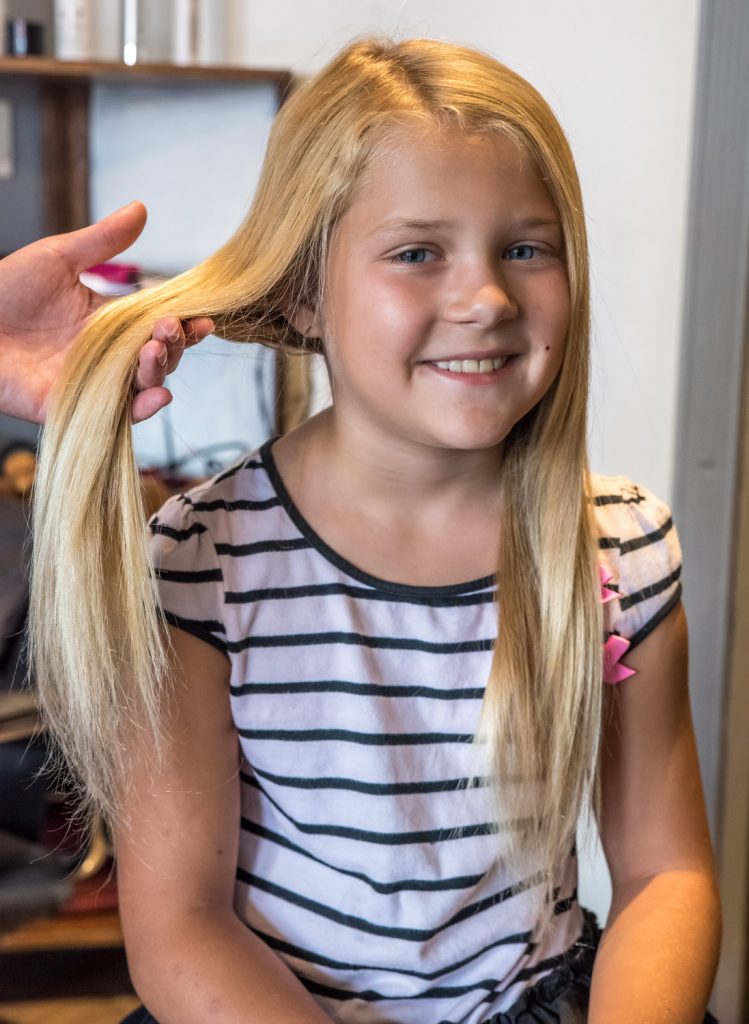 Crystal Zimmerman, 8, from Osoyoos, had the second haircut of her life on Wednesday. Her previous one was two years ago. Both times she has donated her hair to the Angel Hair for Kids program, which provides prosthetic hair pieces to financially disadvantaged children who have lost their own hair to illness. (Richard McGuire photo)