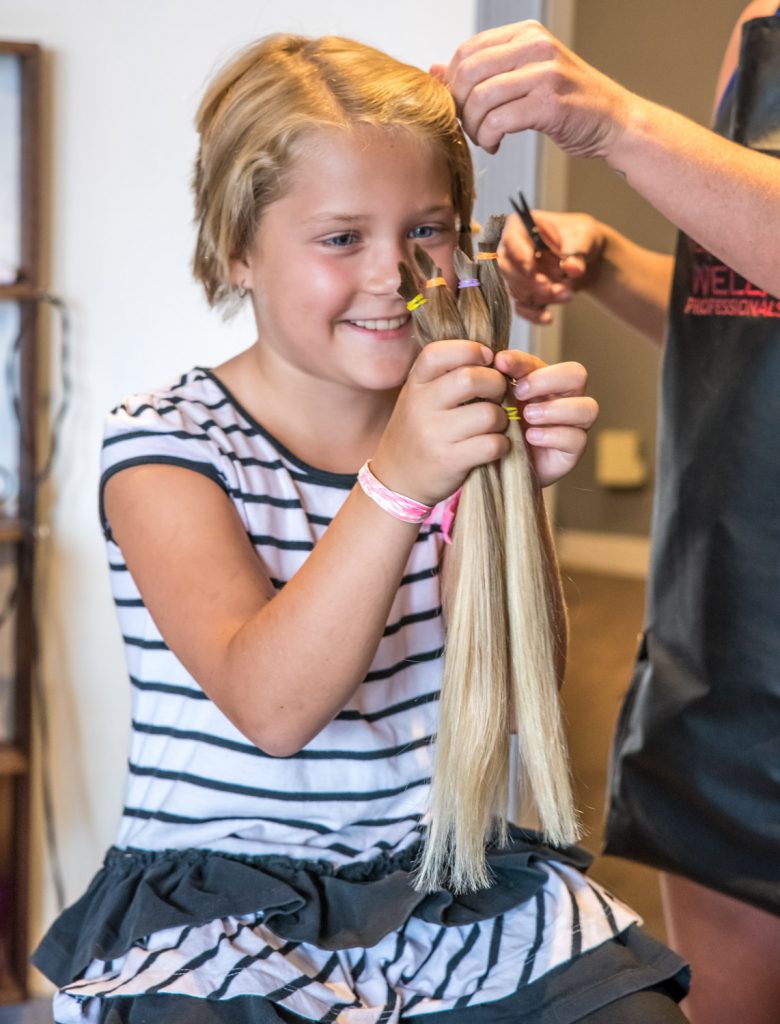 Crystal Zimmerman, 8, from Osoyoos, had the second haircut of her life on Wednesday. Her previous one was two years ago. Both times she has donated her hair to the Angel Hair for Kids program, which provides prosthetic hair pieces to financially disadvantaged children who have lost their own hair to illness. (Richard McGuire photo)