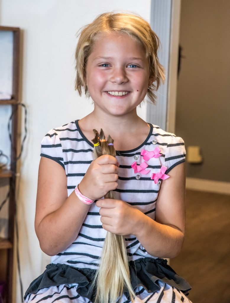 Crystal Zimmerman, 8, from Osoyoos, had the second haircut of her life on Wednesday. Her previous one was two years ago. Both times she has donated her hair to the Angel Hair for Kids program, which provides prosthetic hair pieces to financially disadvantaged children who have lost their own hair to illness. (Richard McGuire photo)
