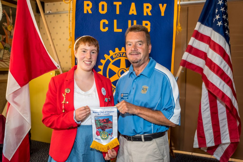 The Rotary Club of Osoyoos has "adopted" Sylvia Mott, left, a teen from Summerland, who they are sponsoring as an "outbound" student on a youth exchange to Germany. At right is club president Brian Rawlings. (Richard McGuire photo)