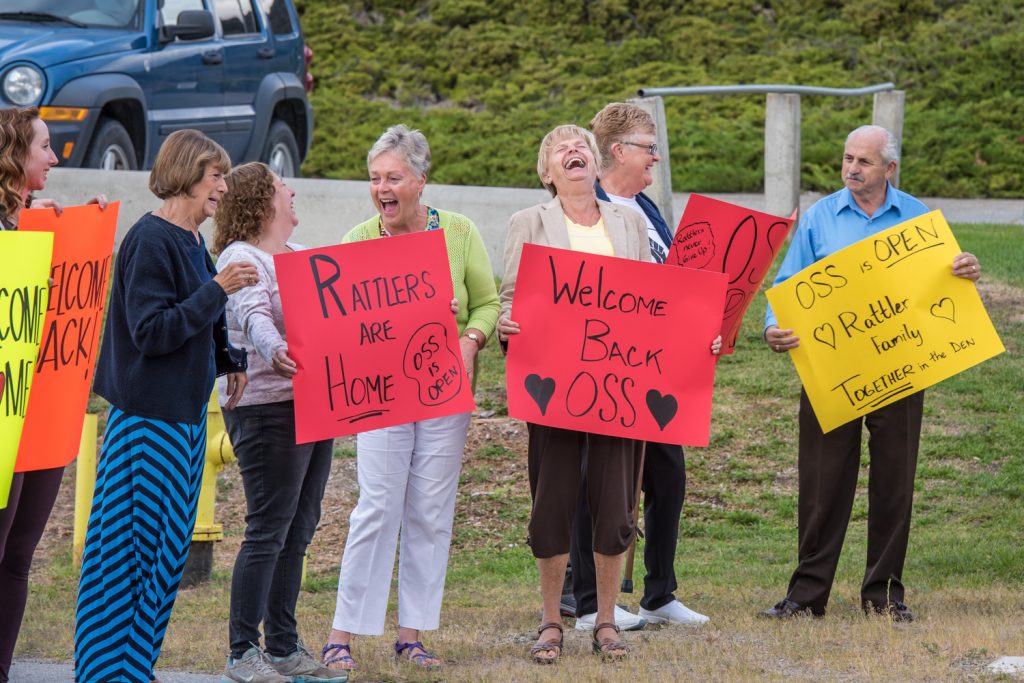 Mayor Sue McKortoff and MLA Linda Larson share a hearty laugh as they welcome students back to Osoyoos Secondary School Tuesday morning along with several dozen other people from the community. Spirits were high as people celebrated that OSS was open after several months earlier this year when it appeared the school would close. (Richard McGuire photo)