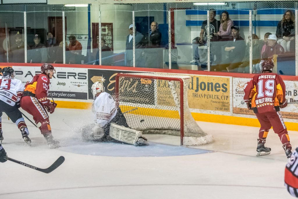 Hunter Robinson (left) adds insult to injury by spraying Princeton goalie Chandler Billinghurst with an icy shower after putting the puck behind him. This was the first goal in a hat trick by Robinson in last Saturday's 8-0 victory over Princeton. (Richard McGuire photo)