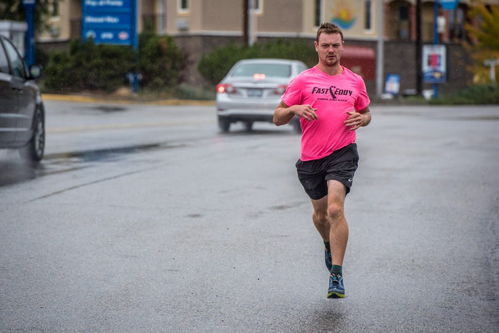 Edward "Fast Eddy" Dostaler takes a run down Main Street in Osoyoos on Saturday. He says he'll have run more than 27,000 km back and forth across Canada, raising money and awareness for Alzheimer's and breast cancer, when he finishes his journey in Victoria at the end of October. (Richard McGuire photo)