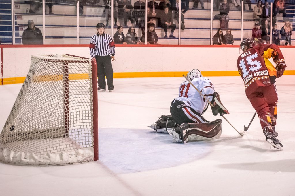 Colin Bell flips the puck past Summerland goalie Matthew Huber to score the Coyotes' fourth goal on a power play. The Coyotes humiliated the division-leading Steam 5-1. (Richard McGuire photo)
