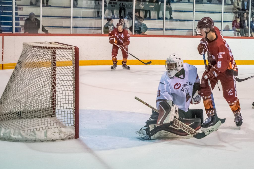 Ryan Roseboom flips the puck past Summerland goalie Matthew Huber to score the Coyotes' fifth goal on a power play. The Coyotes humiliated the division-leading Steam 5-1. (Richard McGuire photo)