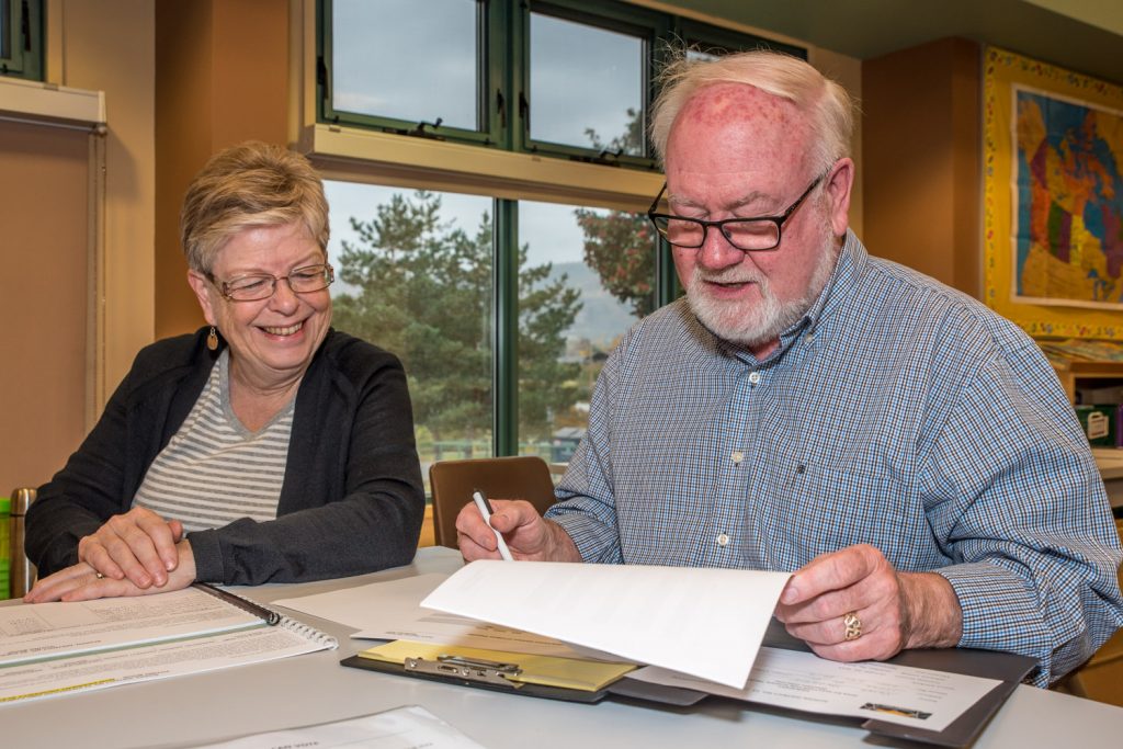 Cathie Paton (left), a poll clerk, listens as Peter Beckett, registration officer, explains a point of voting procedure. The advance poll is open until 8 p.m. today in the library at Osoyoos Elementary School to cast your vote for school trustee. The general voting day is Nov. 5, 8 a.m. to 8 p.m. also in the school library. (Richard McGuire photo)