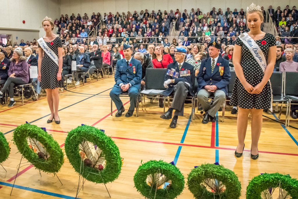 Members of the Osoyoos Royalty stand at attention after laying a wreath. At left is Princess Laura Devries and at right is Miss Osoyoos Emmaleigh Diwell. (Richard McGuire photo)