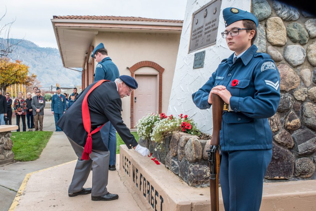 Sergeant-at-Arms Lew Taylor lays a ceremonial poppy as an act of remembrance at the cenotaph. (Richard McGuire photo)