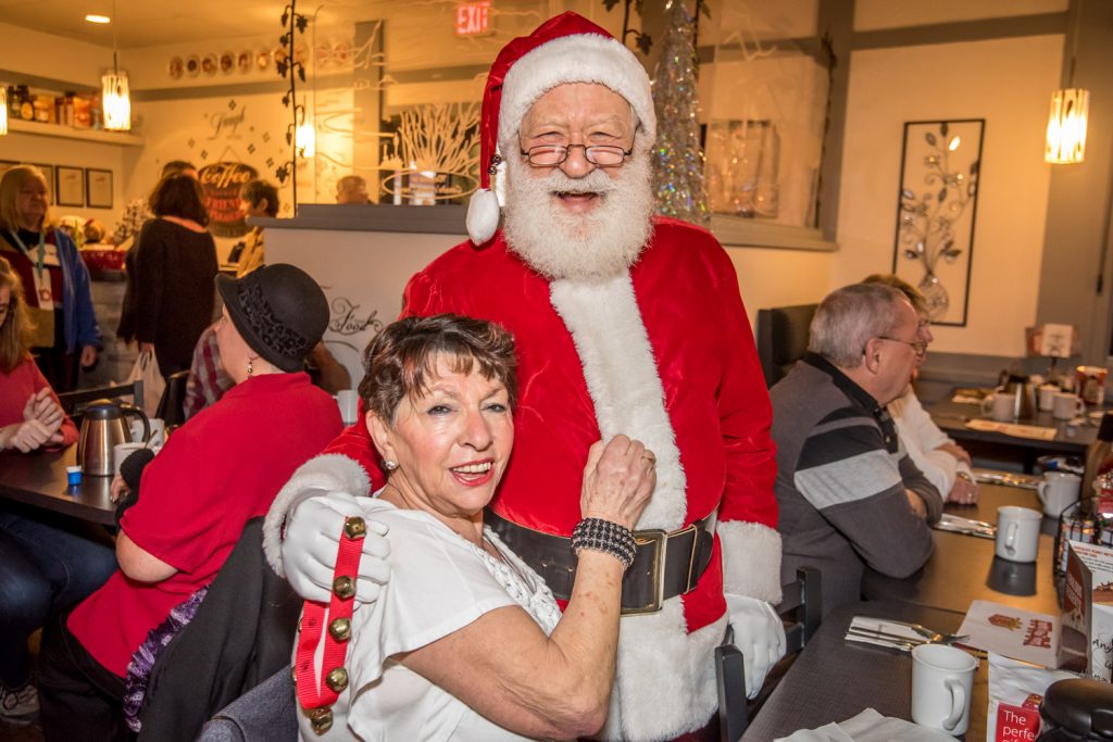 Santa Claus made the rounds of Smitty's Family Restaurant Friday morning greeting customers like Rosa Tortora, pictured here. The occasion was the annual Smitty's Toys for Tots to Teens event where the restaurant provides free breakfast for those who donate a toy or cash to the Kiwanis "Share the Christmas Spirit" program. (Richard McGuire photo)