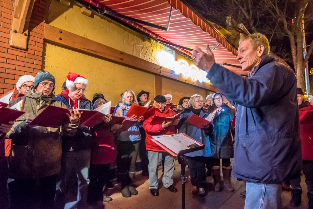 The Okanagan International Chorus, conducted by Lloyd Fairweather, sang Chistmas carols in front of Osoyoos Home Hardware before the parade Friday evening during Christmas Lite-Up. (Richard McGuire photo)