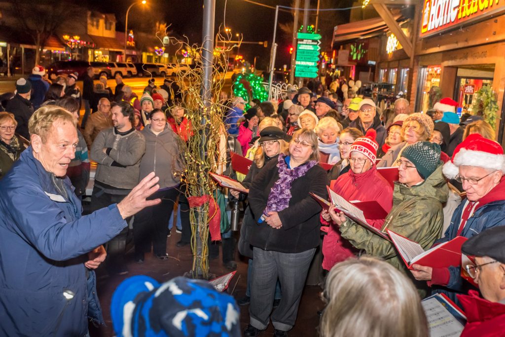 The Okanagan International Chorus, conducted by Lloyd Fairweather, sang Chistmas carols in front of Osoyoos Home Hardware before the parade Friday evening during Christmas Lite-Up. (Richard McGuire photo)