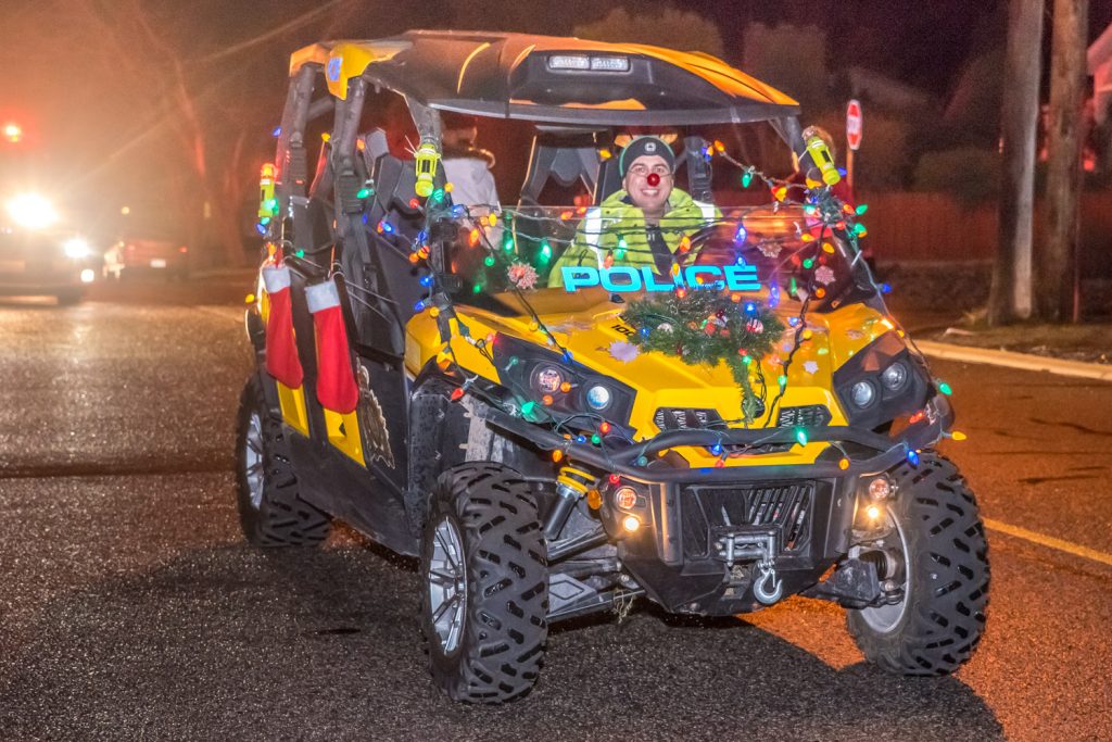 Wearing a shiny Rudolph nose, Constable Sheldon Herman of Osoyoos RCMP drove a decked out police ATV in the Santa Parade. (Richard McGuire photo)