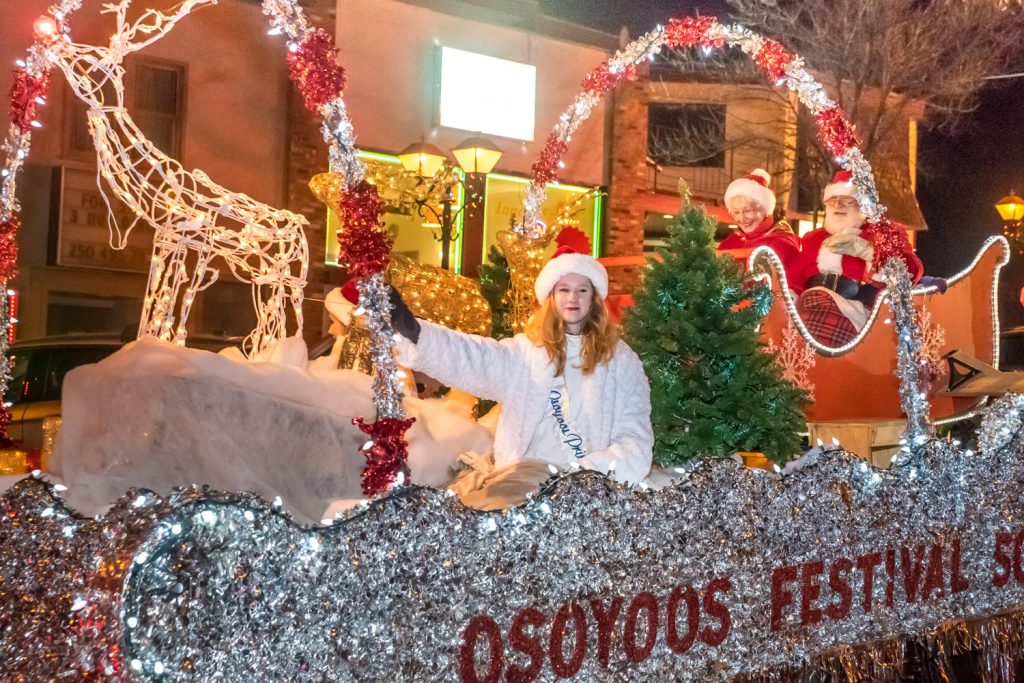 Princess Laura Devries gives a royal wave from the Osoyoos Festival Society float in the Santa Parade. Behind her are Santa and Mrs. Claus. (Richard McGuire photo)