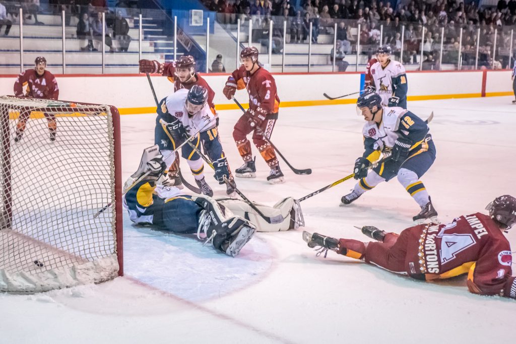 With just 1:21 remaining in the third period, Hunter Johnson scored on a power play to tie the score 3-3 and force the game into overtime. Johnson is the second Coyote from the left above the goalie. (Richard McGuire photo)
