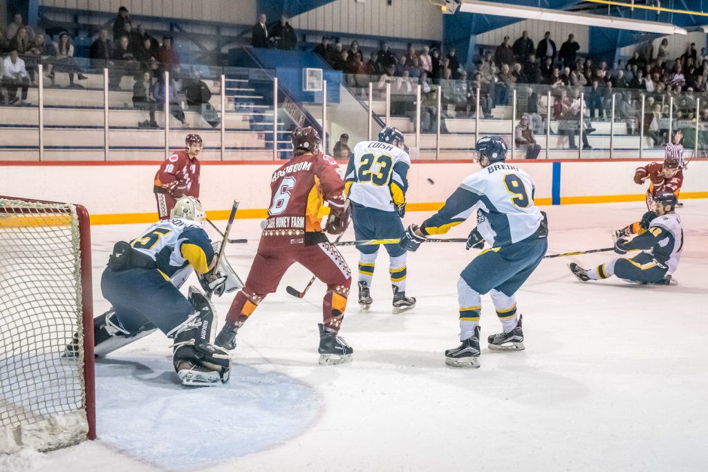Just 23 seconds into overtime, Austin Steger (far right) flipped the puck though a maze of players into the net to win the game for Osoyoos. The puck can be seen here between players 23 and 9 as it makes its way to the net. (Richard McGuire photo)