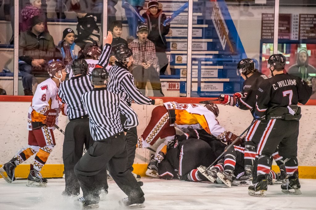 The Osoyoos Coyotes and Summerland Steam came to blows several times during Friday night's game. In this incident in the final minute of the second period, Judd Repole of the Coyotes and Calvin Rout of the Steam both took 10-minute misconducts and Colton Rhodes took a minor for slashing. (Richard McGuire photo)