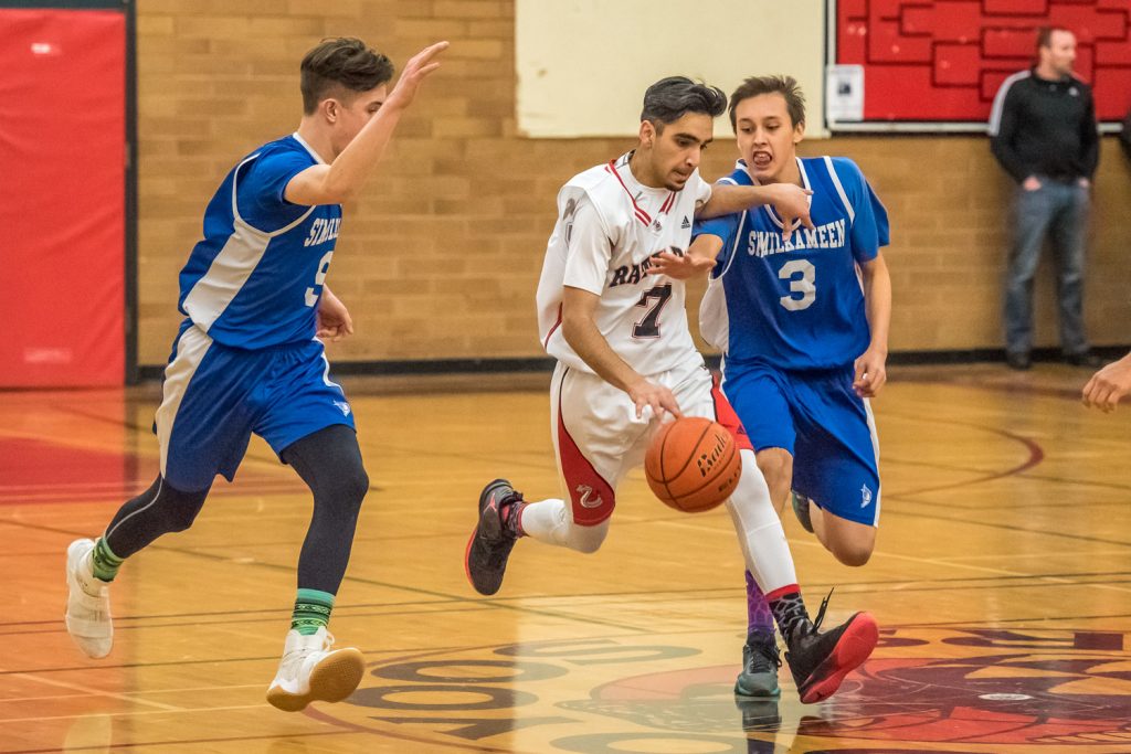 Keremeos players try to throw up obstackes to Arshdeep Gill of the Osoyoos Rattlers as he advances with the ball. (Richard McGuire photo)