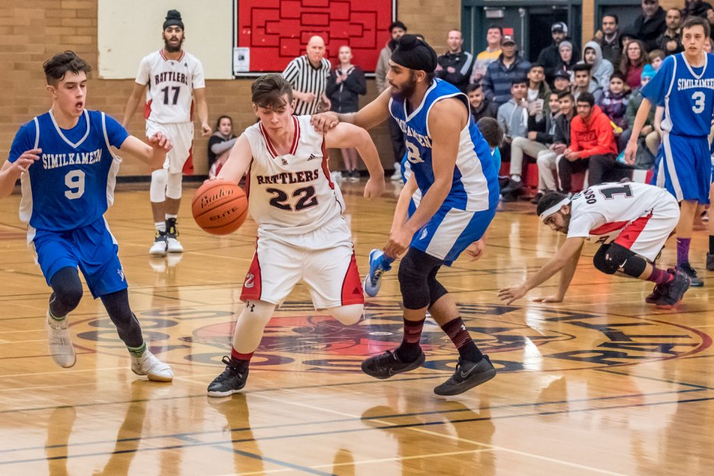 Justin Davis of the Osoyoos Rattlers advances with the ball as a couple Keremeos players try to get in his way. (Richard McGuire photo)