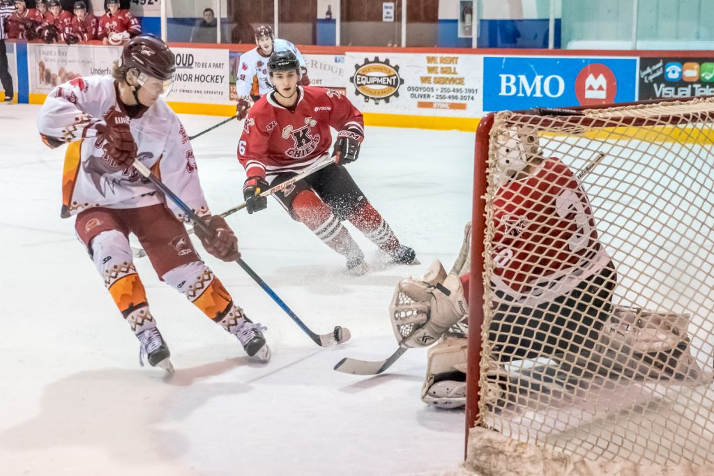 Sam Reinbolt (left) shoots from close range to score the Coyotes' first goal in their game against Kelowna Saturday night. (Richard McGuire photo)