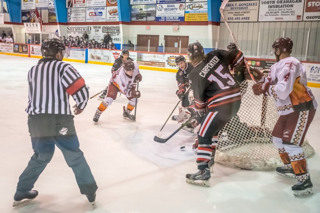 Connor Onstein, to the right of the referee, spotted a loose puck in front of the net and flipped it in to score the Coyotes' first goal Saturday night. (Richard McGuire photo)