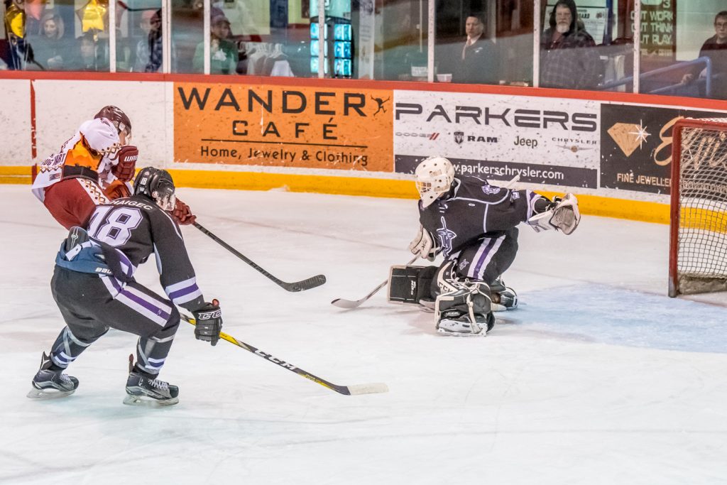 Sam Reinbolt fires the puck past North Okanagan goalie Daniel Paul to put the Coyotes head 2-1 in the second period in the opening playoff game Friday night. (Richard McGuire photo)