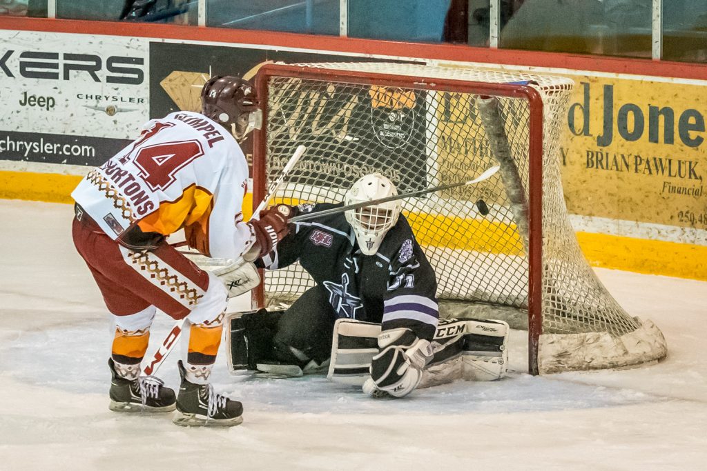Jackson Glimpel shots at close range to score the Coyotes' fourth goal Friday night against the North Okanagan Knights. (Richard McGuire photo)