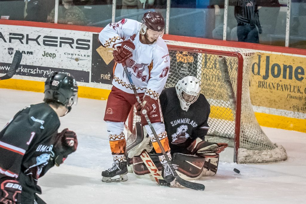 Coyote Hunter Johnson parks on Summerland goalie Matthew Huber's doorstep as he tries to knock in a lose puck. (Richard McGuire photo)