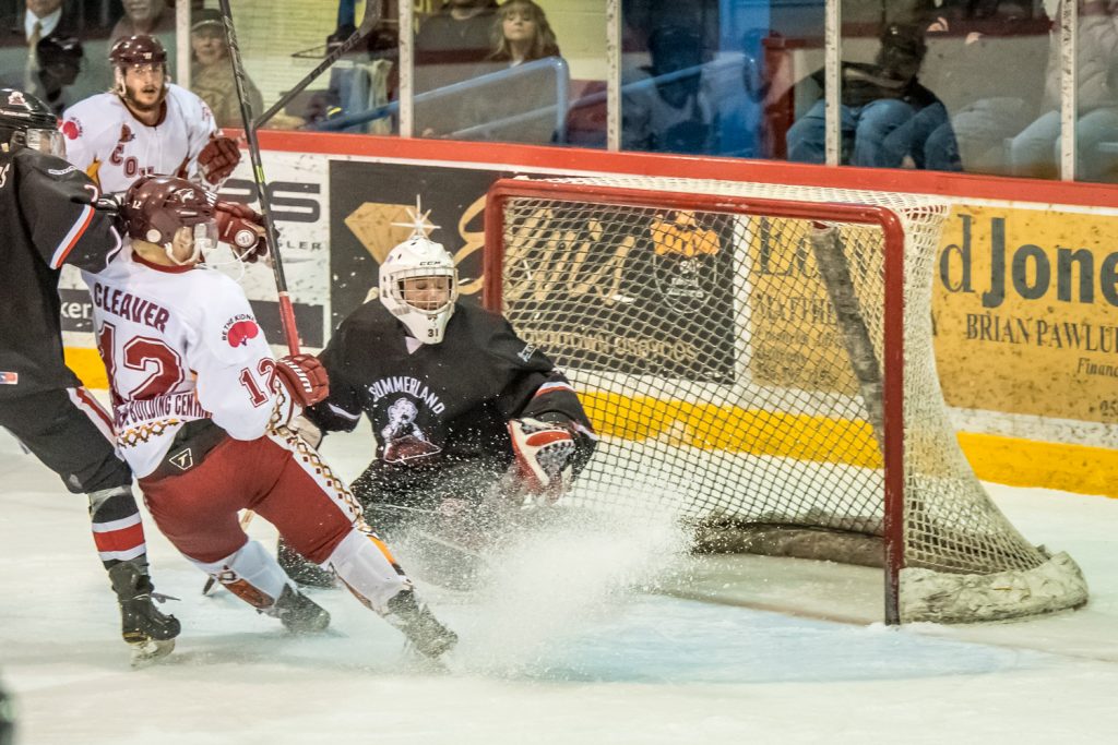 Austin Cleaver sprays Summerland goalie Matthew Huber with ice, but Huber managed to grab the puck. (Richard McGuire photo)