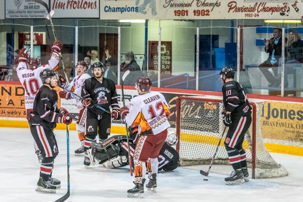 Reid Wilson, Jackson Glimpel and Austin Cleaver celebrate after Glimpel scores the winning goal on a power play Wednesday. (Richard McGuire photo)