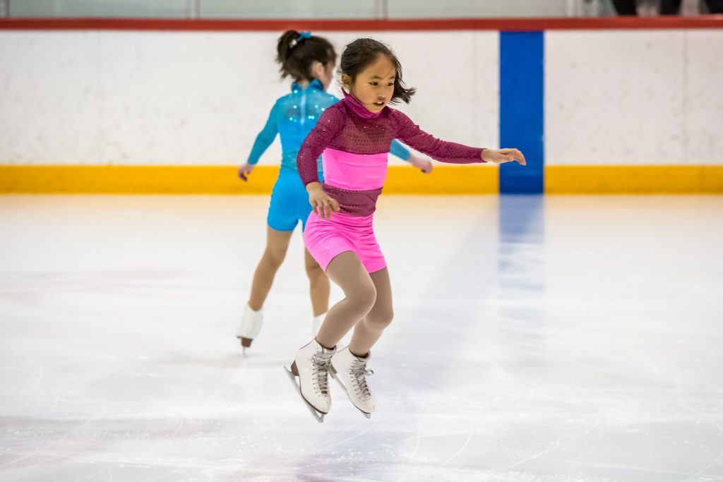 Stella Chen does a jump in the Junior Starskate. Behind her is Willow Logan. (Richard McGuire photo)