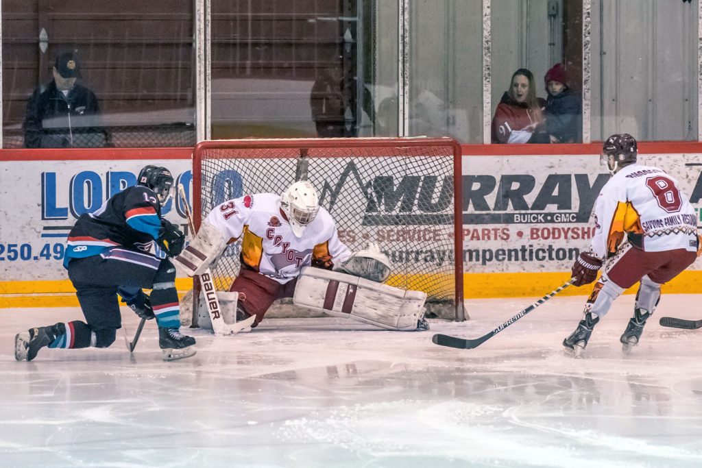 Kaden Black shoots the puck through Coyotes goalie Adam Jones' legs to score the Heat's second goal. (Richard McGuire photo)