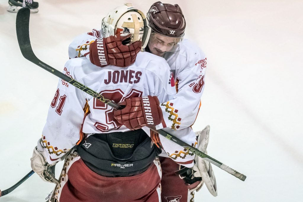 Connor Onstein comforts Coyote goalie Adam Jones after Osoyoos ended its playoff run losing to Chase 3-1. Jones played in net for all but one of the playoff games and was a major reason the Coyotes got as far as they did. (Richard McGuire photo)