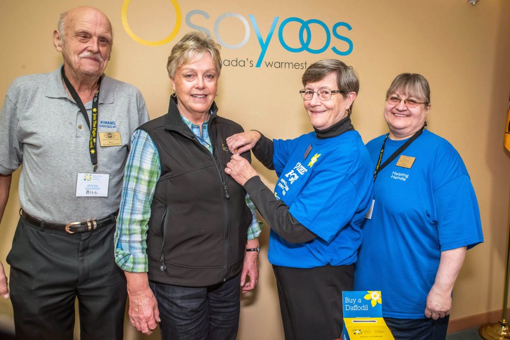 Donna Kelso, secretary-treasurer of the Osoyoos Kiwanis Club, pins a daffodil onto Mayor Sue McKortoff after the mayor proclaimed April as Daffodil Month in Osoyoos. On the left is Bill Ashdown, a Kiwanis director, and on the right is Myra Mohninger, club president. The club will be placing daffodil pins with local businesses to raise money for the Canadian Cancer Society. (Richard McGuire photo)