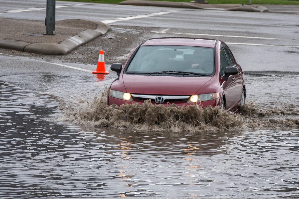 When heavy rains hit on Friday, a small pond formed on Hwy. 3 at the Osoyoos Visitor Centre. Big trucks barrelled through, sending water in all directions, while small cars gingerly inched forward as water reached above their axels. (Richard McGuire photo)