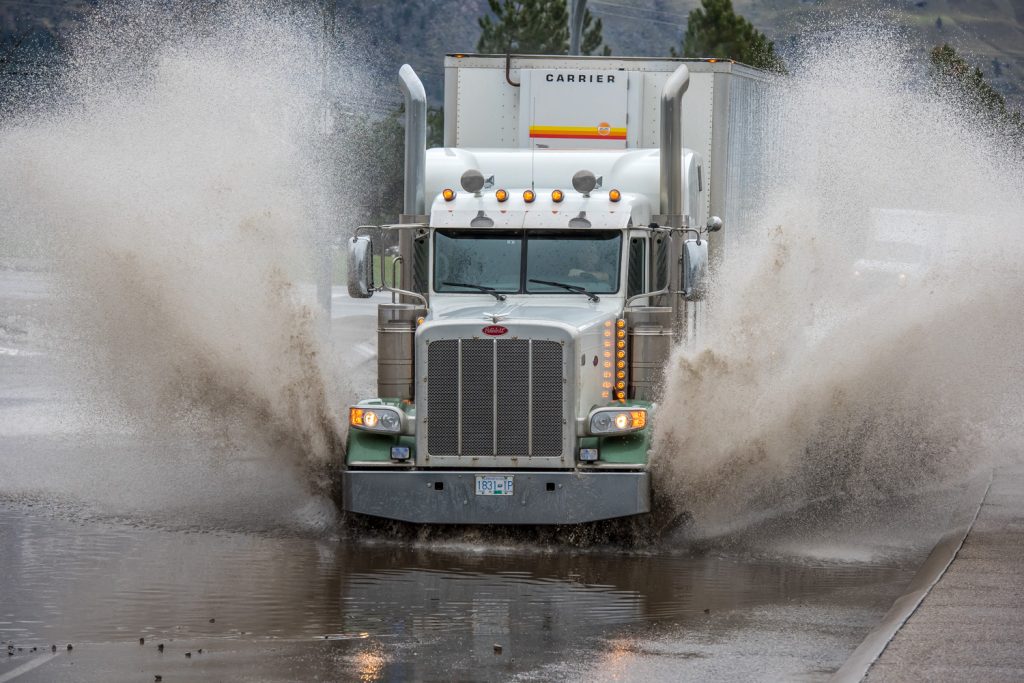 When heavy rains hit on Friday, a small pond formed on Hwy. 3 at the Osoyoos Visitor Centre. Big trucks barrelled through, sending water in all directions, while small cars gingerly inched forward as water reached above their axels. (Richard McGuire photo)