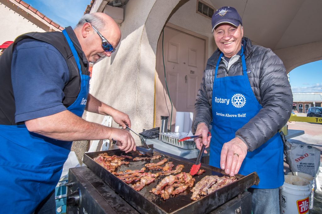 Doug Matthews (left) and Harold Cox are the Osoyoos Rotarians in charge of makin' bacon at the Rotary Pancake Breakfast Saturday morning at Easter Eggstravaganza. (Richard McGuire photo)