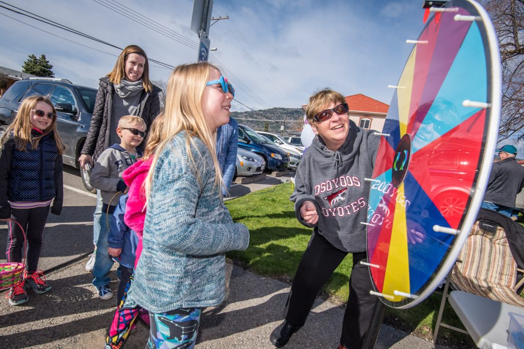 Morgan Taylor, 9, from Mission, B.C. watches the wheel spin during a prize-winning game at Easter Eggstravaganza. Overseeing the game (right) is Elaine Taylor, no relation to Morgan. (Richard McGuire photo)