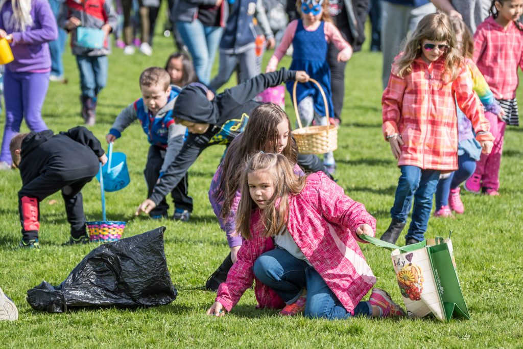 Children took a few seconds to scoop up thousands of candy Easter eggs during the Easter egg hunt in the playground at Osoyoos Elementary School. (Richard McGuire photo)