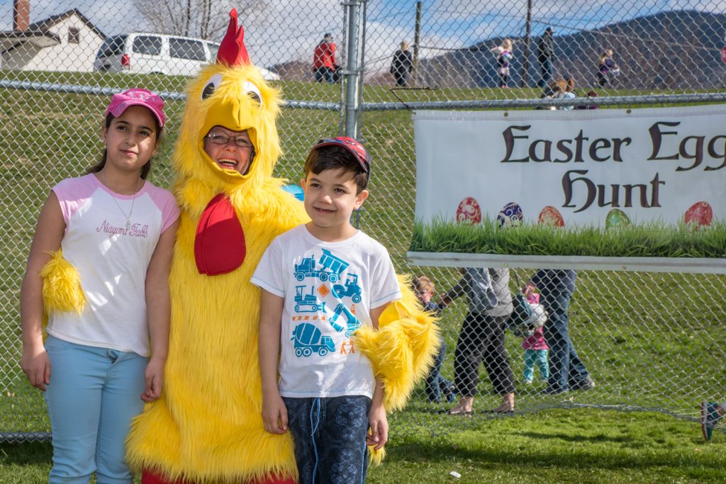 Fatima and Samer Tabanjat visit with the Easter chicken after the egg hunt. (Richard McGuire photo)
