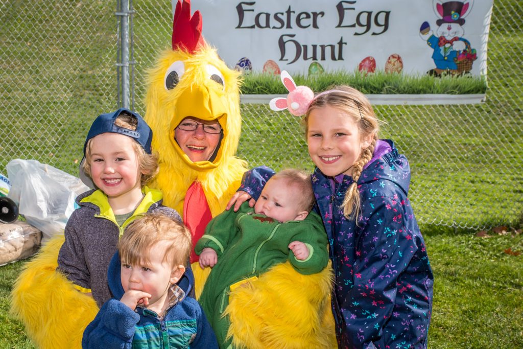 These children enjoyed some chicken after the Easter egg hunt. From left are Von Cooper, Hugo Rothe, Vale Cooper and Elle Cooper. Playing the chicken is Annette Star. (Richard McGuire photo)