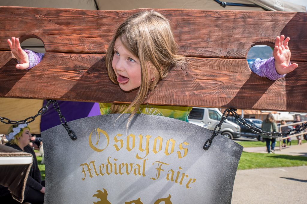 Charlotte Fichten, 5, of New Westminster, tried out a pillory on Saturday at Town Square. The pillory was there to promote the Osoyoos Medieval Faire, which is coming to Desert Park on the May long weekend. (Richard McGuire photo)