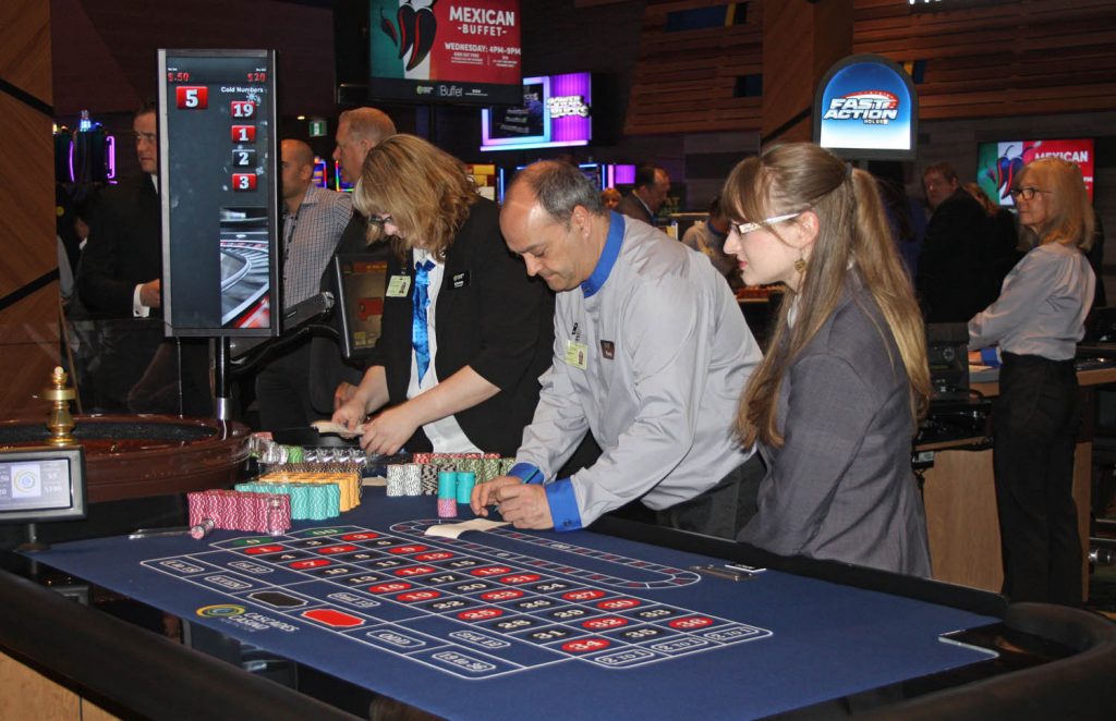 Casino employees get prepared at one of the gaming tables. (Keith Lacey photo)