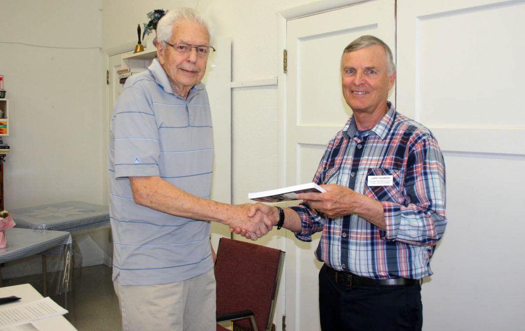 George Fraser (left) was the special guest speaker at the Oliver Osoyoos branch of the Okanagan Historical Society, which held its annual general meeting this past Sunday afternoon at the Osoyoos United Church. Fraser provided a humourous and heartfelt recollection of his early years growing up in Osoyoos. His family was one of the founding pioneers of this community. Larry Shannon, the president of the local chapter, presented Fraser with the society’s latest annual report as a gift. (Keith Lacey photo)