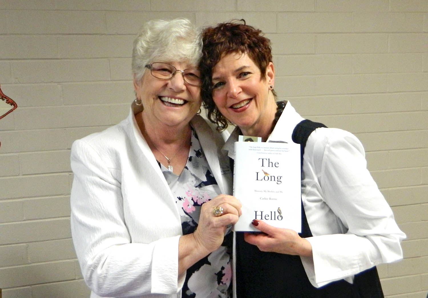 Cathie Borrie (right) recently spoke about her book The Long Hello - Memory, My Mother and Me at an event hosted by the Desert Valley Hospice Society. Pictured with her (left) is Trudy Demorest, one of the founding members of the society. Borrie’s book tells about the emotional rewards and challenges she experienced while caring for her mother with Alzheimer’s disease. The event was held on April 16 at the Osoyoos Secondary Community Theatre. (Photo supplied)