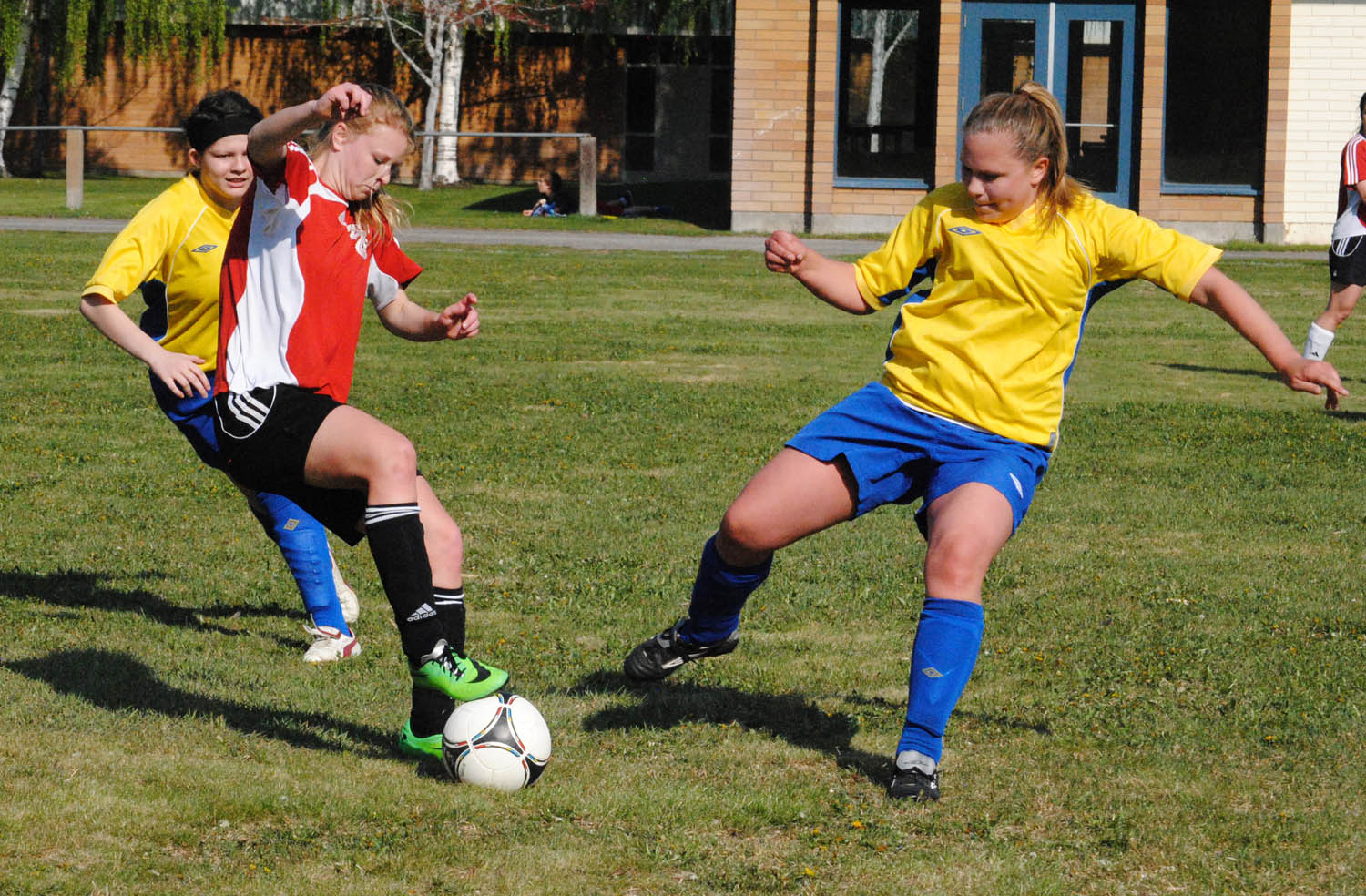 Sami Luinenburg (centre) from the Osoyoos Rattlers senior girls soccer team, tries to elude tacklers during tournament action this past weekend at the OSS soccer fields. (Dale Cory photo)